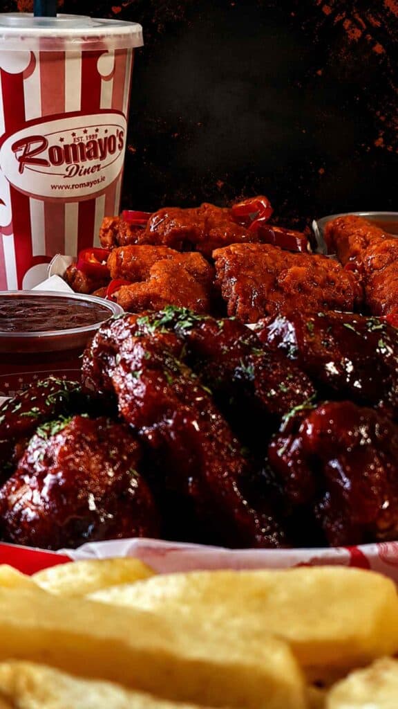 Delicious chicken wings, fries, and soft drink from Romayo's.
