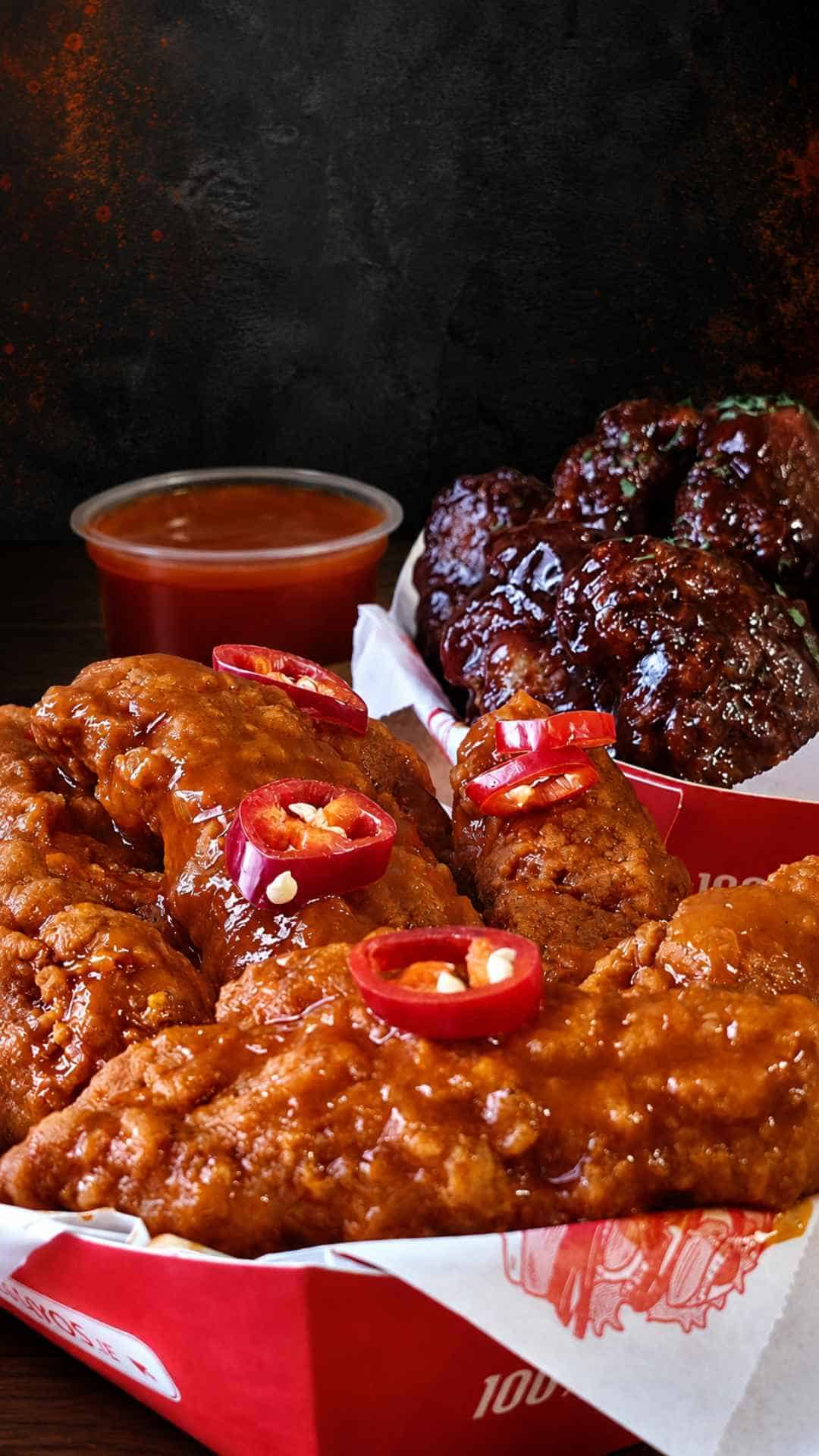 Delicious chicken wings and meatballs with spicy sauce at Romayo's.